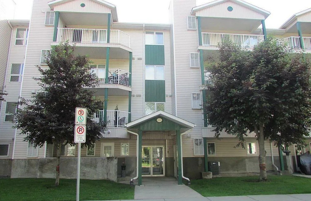 Apartment complex with a no parking sign in front.